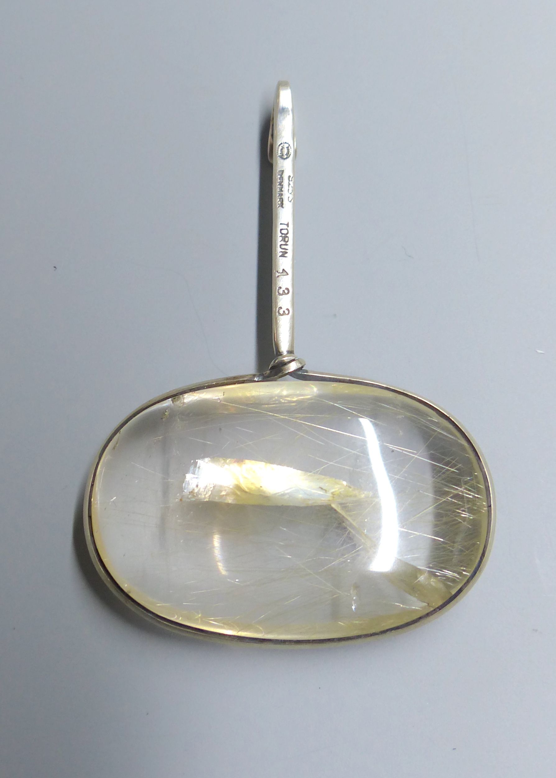 A Georg Jensen sterling and rutilated quartz set Vivianna Torun oval pendant, no. 133, 65mm.